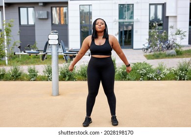 Fat Afro American Woman Warming Up Body Before Outdoor Running. Getting Ready For Jogging. Sport, Activity, Healthy Lifestyle And Weight Loss. Side View Portrait, Copy Space