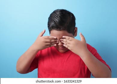 Fat Asian Boy Looking Down, Sad And Crying, Being Bullied, Sadness, Child Abuse Concept, Against Blue Background