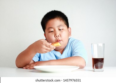 
Fat Asian children are eating pizza on a white table with soda nectar. White background. Child weight control concepts