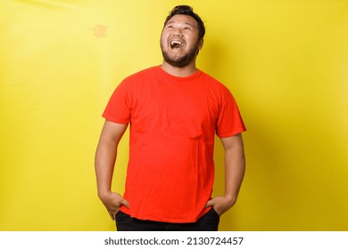 Fat Asian Guy Laughing Loudly Isolated On Yellow Background