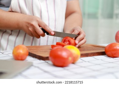 Fat Asian Woman Cooking In Kitchen And Chopping Fresh Organic Vegetables On Chopping Board. Learn To Make Salads And Healthy Food From Social Media. Health Care Concept Eat Healthy Food To Lose Weight