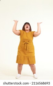 Fat Asian Woman Standing On A White Background, She Poses For Carrying A Heavy Load. Weight Loss Concept. Fashion Dress For Fat People