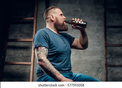 Fat Bearded Man Drinking Beer From A Bottle.