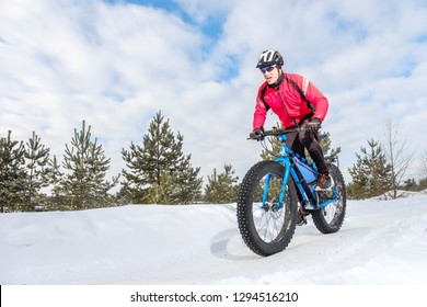 Fat biker riding his bicycle in the snow during winter. Fat bike. - Powered by Shutterstock