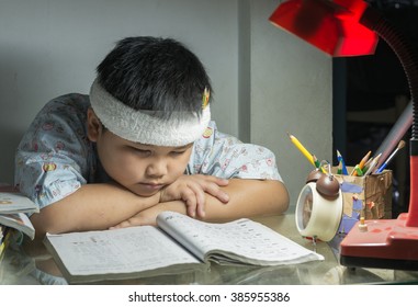 Fat Boy Reading A Book For Exam On Night