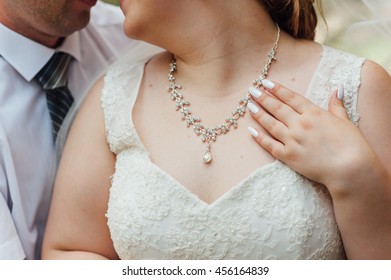 The Fat Bride Wears A Necklace Around His Neck.