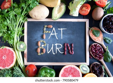 Fat Burn On A Chalkboard Surrounded By Fresh Detox Food Ingredients