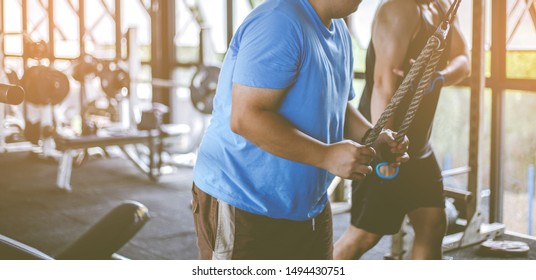 Fat Fitness Men With Trainer Exercising At Fitness Gym. Man Diet Lifestyle Concept To Reduce Belly And Shape Up Healthy Stomach Muscle. Fat Man, Fat Boy.