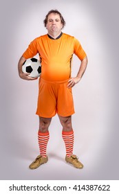 Fat Football Soccer Player With Ball. Recreation Footballer Carries A Ball. Proud Fat Football Player Carries The Ball.