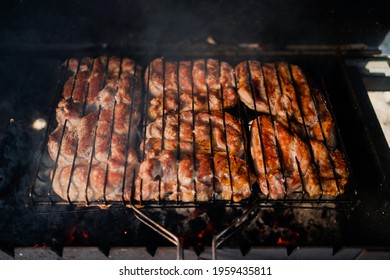 Fat Fried Red Meat On A Metal Grill In The Village In The Summer. Fire The Coals For Frying.