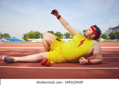 Fat Funny Man Doing A Selfie On The Phone In The Stadium.