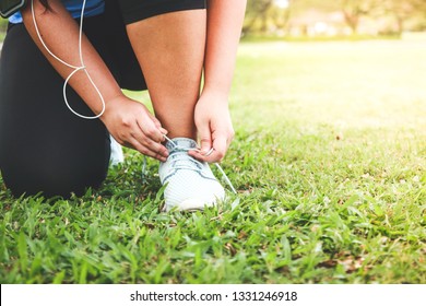 Fat girl exercising in the garden Sit to tie shoes to run. - Powered by Shutterstock