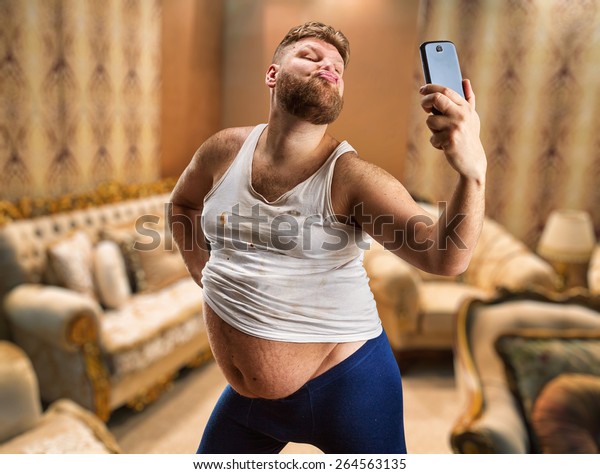 Fat\
glamour man with beard takes selfie in his\
bedroom