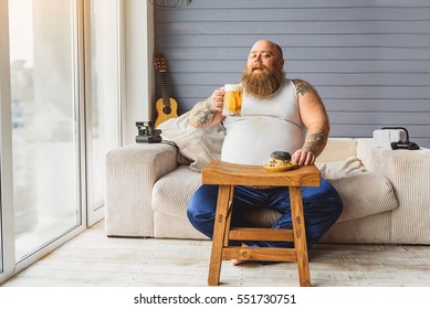 Fat guy relaxing with alcohol drink