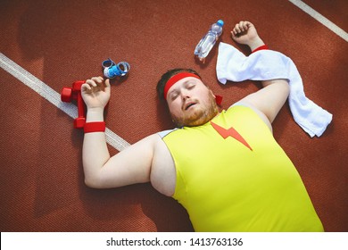 Fat Lazy Man Sleeps Tired Lies On The Track In The Stadium.