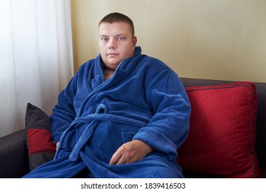 A Fat Man In A Bathrobe Sits On The Couch At Home, Wrong Lifestyle Concept.