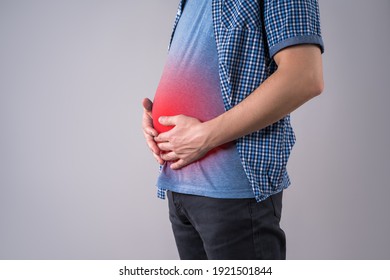 Fat Man With Bloating And Abdominal Pain, Overweight Male Body On Gray Background, Studio Shot