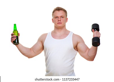 Fat man with a bottle of beer holds dumbbells isolated on white. The concept of choosing between harmful food and a healthy lifestyle. Portrait of overweight person who spoiled healthy meal . Junk
