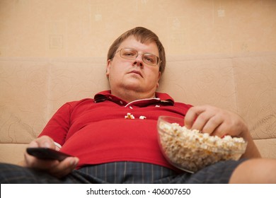 fat man eating popcorn