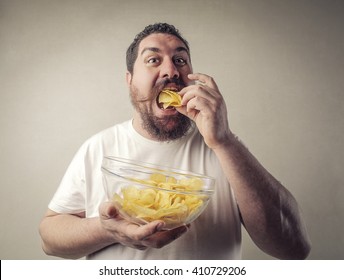 Fat Man Eating Potato Chips