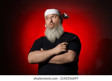 A Fat Man With A Gray Beard And A Bandage On His Head Crossed His Arms With A Gun In Front Of Him On A Dark Background