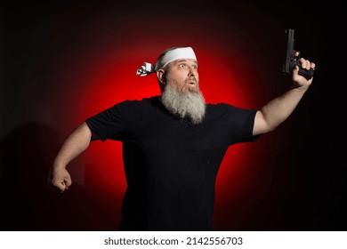 A Fat Man With A Gray Beard Runs With A Gun In His Hand On A Dark Background