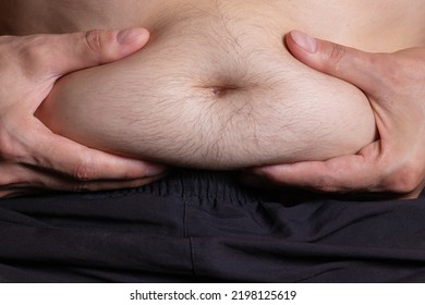 Fat Man Holding Excessive Fat Belly, Overweight Fatty Belly Isolated Grey Background. Diet Lifestyle, Weight Loss, Stomach Muscle, Healthy Concept.