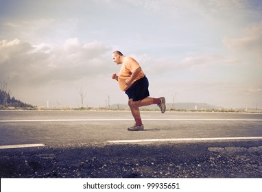 Fat man jogging on a country road