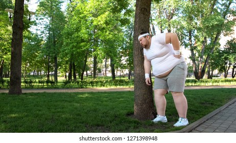 Fat Man Leaning On Tree, Tired After Workout On Fresh Air, New Healthy Habit