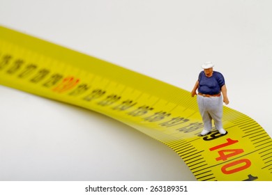 Fat Man And Measurer - Obesity Concept