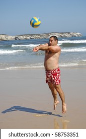 A Fat Man Playing With A Ball On The Beach