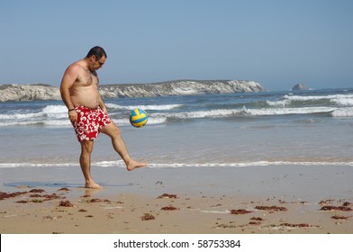 A Fat Man Playing With A Ball On The Beach