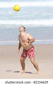 A Fat Man Playing With A Ball On The Beach