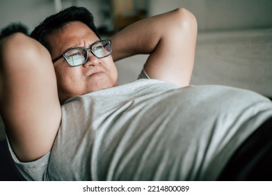 Fat man practicing doing crunches or sit ups on yaga mat, fitness program for weight loss, healthy lifestyle concept, copy space