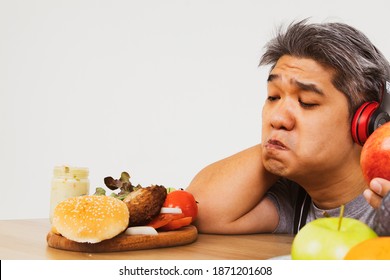 The Fat Man Regrets His Favorite Hamburger: The Man, Looking Down On The Pork With Regret, Decides Not To Eat The Hamburger Lying On The Table.