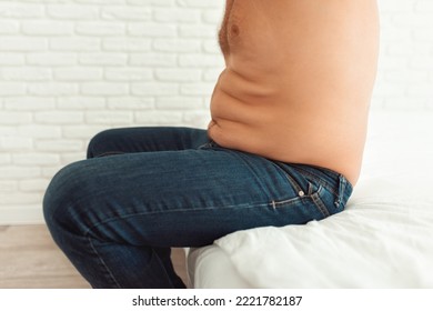 A Fat Man Sits With Fat Folds On His Stomach