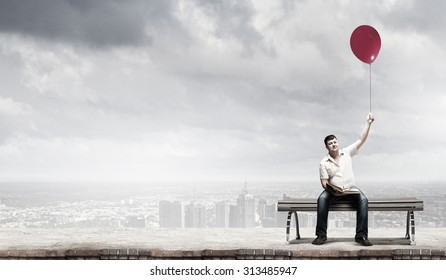 Fat man sitting on bench with book and balloon in hand - Powered by Shutterstock