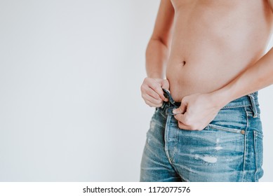 Fat Man Trying So Hard To Put Down His Jeans Pant Button, Stuck Because His Big Fat Belly, Check Out His Body Fat Suffering From Extra Weight, Fitness And Diet Concept Isolated On White Background