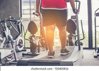 Fat Man Walking On Treadmill At Fitness Gym 