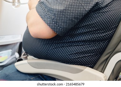 Fat Obese Man Passenger Fastening Seat Belt On Airplane, Problem Safe Flight.