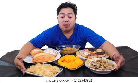 Fat Or Overweight Asian Man Huging At  A Lot Of Unhealthy Food On The Table Isolated In White, Fat Man Greed Concept, Diet Concept