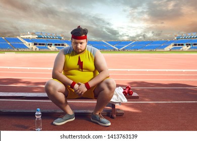 Fat Sad Man Sitting In A Stadium After Training.