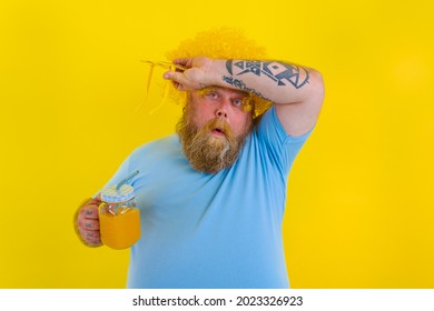 Fat Tired Man With Wig In Head And Sunglasses Drinks A Fruit Juice