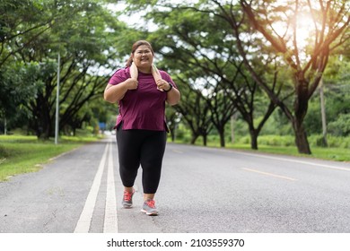 Fat woman asian running at the park, Does exercise for weight loss idea concept.