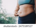 fat woman, fat belly, chubby, obese woman hand holding excessive belly fat with measure tape, woman diet lifestyle concept