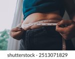 fat woman, fat belly, chubby, obese woman hand holding excessive belly fat with measure tape, woman diet lifestyle concept