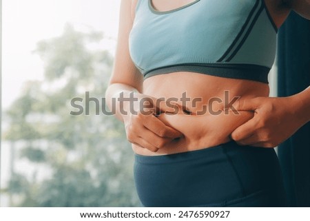 fat woman, fat belly, chubby, obese woman hand holding excessive belly fat with measure tape, woman diet lifestyle concept