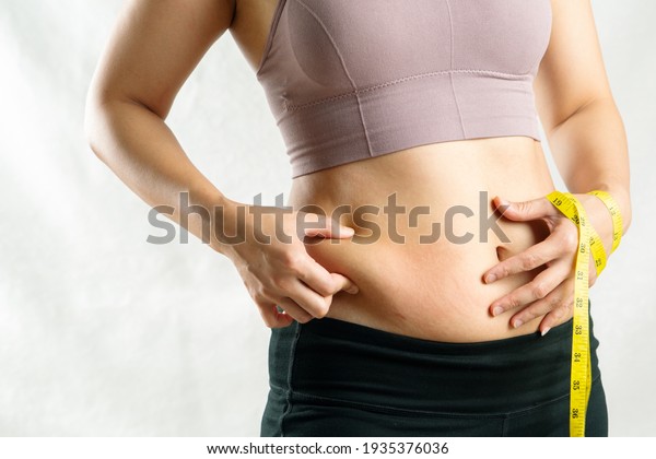 fat\
woman, fat belly, chubby, obese woman hand holding excessive belly\
fat with measure tape, woman diet lifestyle\
concept