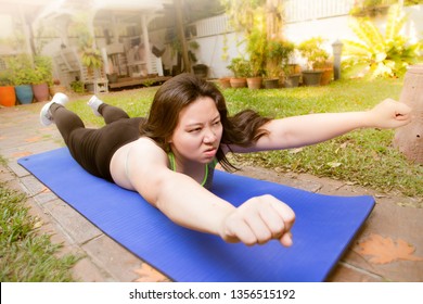 Fat Woman Exercise Funny Face Lying Down Superman Pose On Yoga Mat At Home