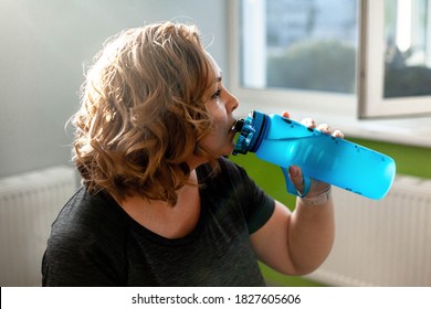 Fat Woman Fights Overweight In The Gym, Doing Heavy Fitness Exercises For Future Strong Body. Obese Person Tired And Drink Water
